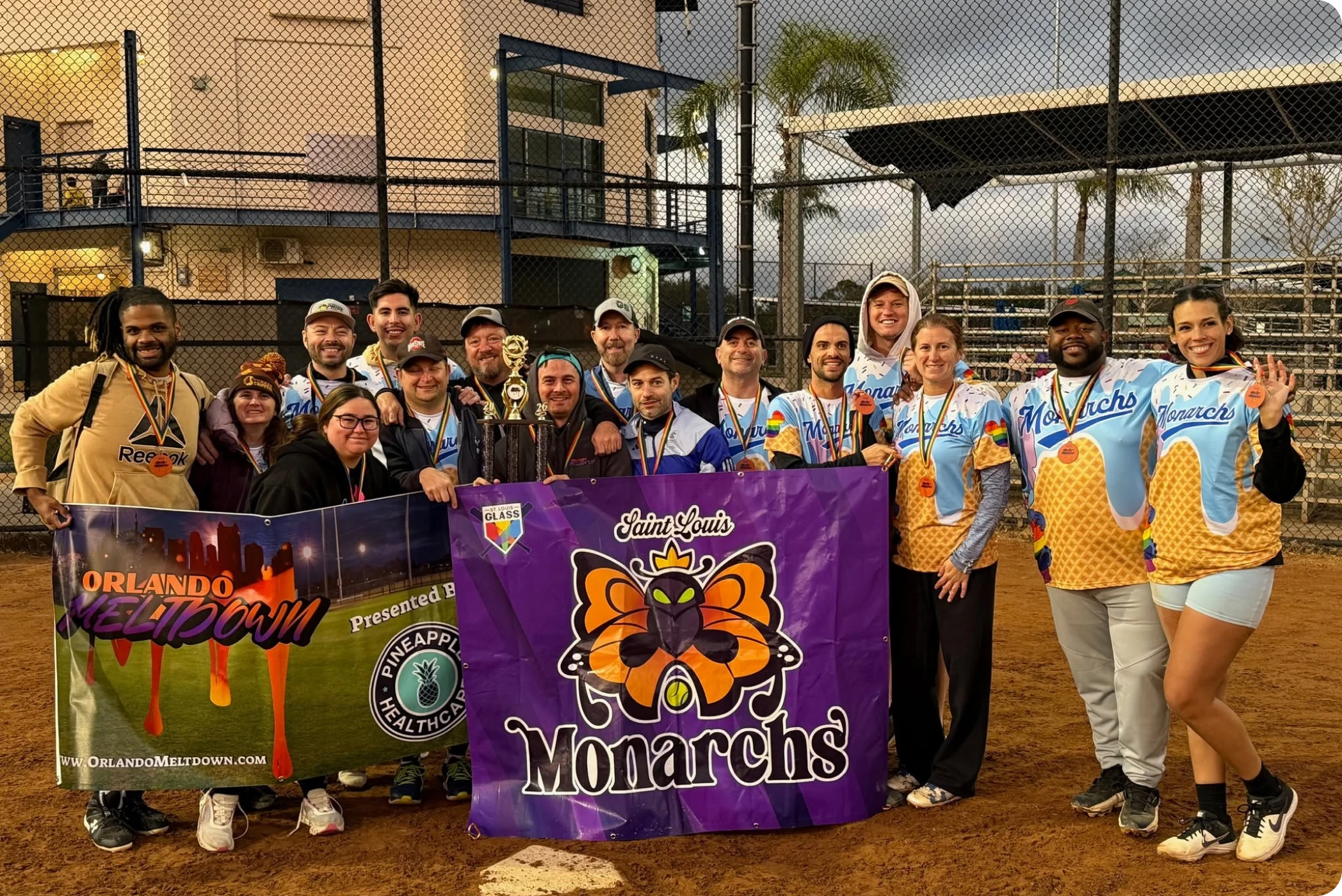 Team members smiling on baseball field